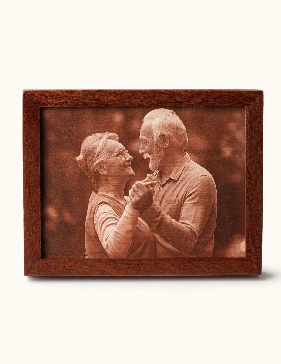Laser-engraved leather portrait of a smiling couple dancing, framed in wood — a heartfelt 3rd wedding anniversary gift celebrating love and lasting memories