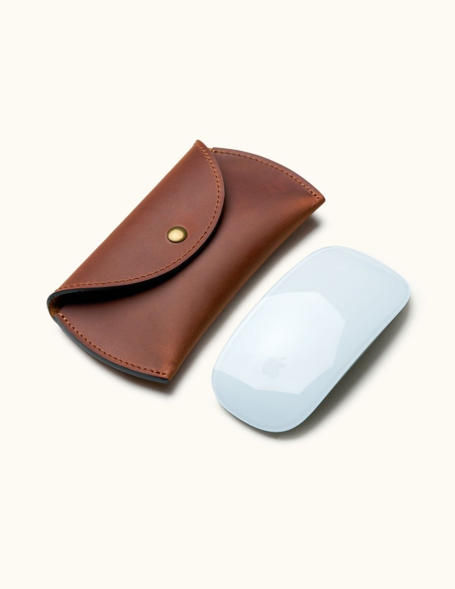 Full-grain leather case shown next to Apple Magic Mouse to illustrate size and fit