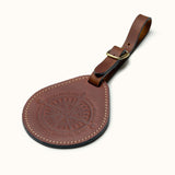 Full-grain leather round luggage tag with compass design and brass buckle strap
