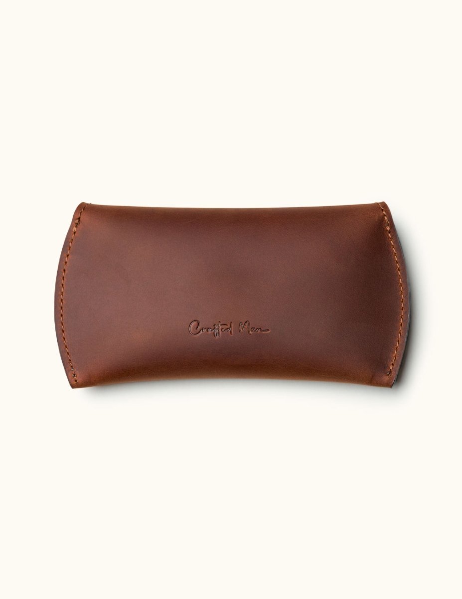 Handmade brown leather sleeve for Apple Magic Mouse, closed with embossed Crafted Man logo
