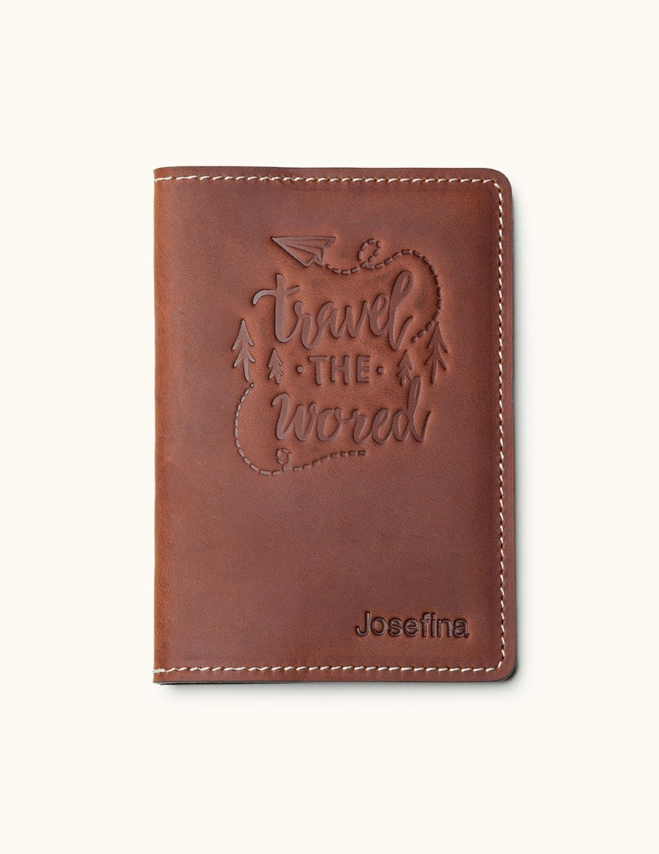 Brown leather passport cover with 'Travel the World' design and personalized name – ideal for travelers