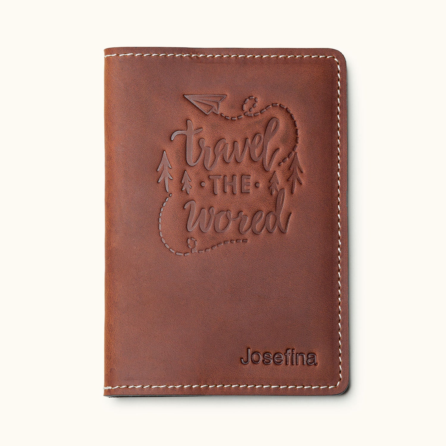 Brown leather passport cover with 'Travel the World' design and personalized name – ideal for travelers