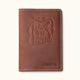 Brown leather passport cover with 'Travel the World' design and personalized name – ideal for travelers