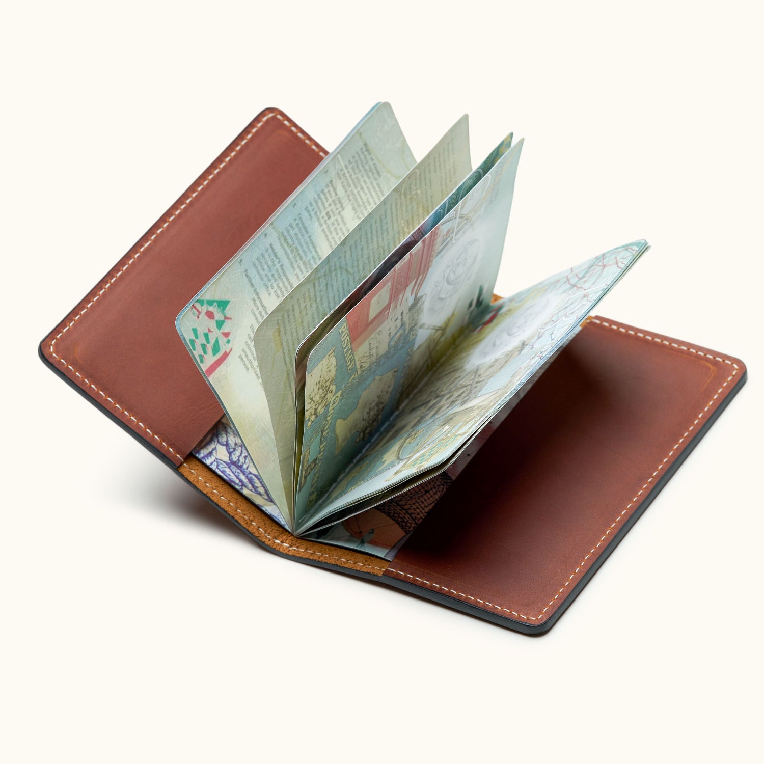 Open brown leather passport holder showing passport pages – minimalist travel wallet for frequent flyers