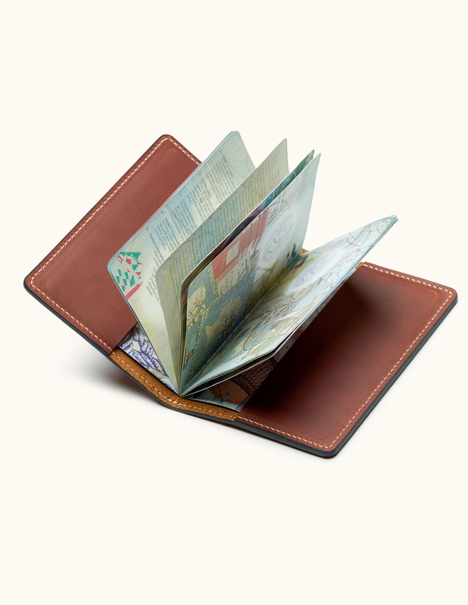 Open brown leather passport holder showing passport pages – minimalist travel wallet for frequent flyers