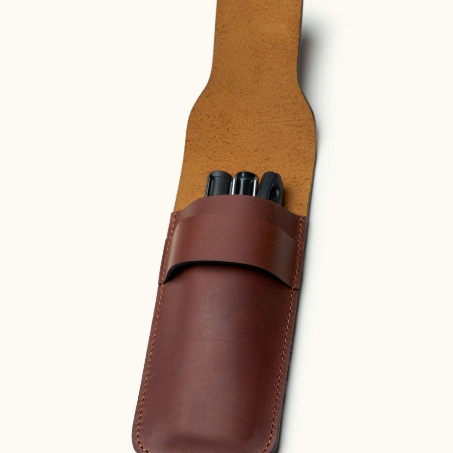 Full-grain leather pen case for three fountain pens, open view showing pens inside a slotless handcrafted design