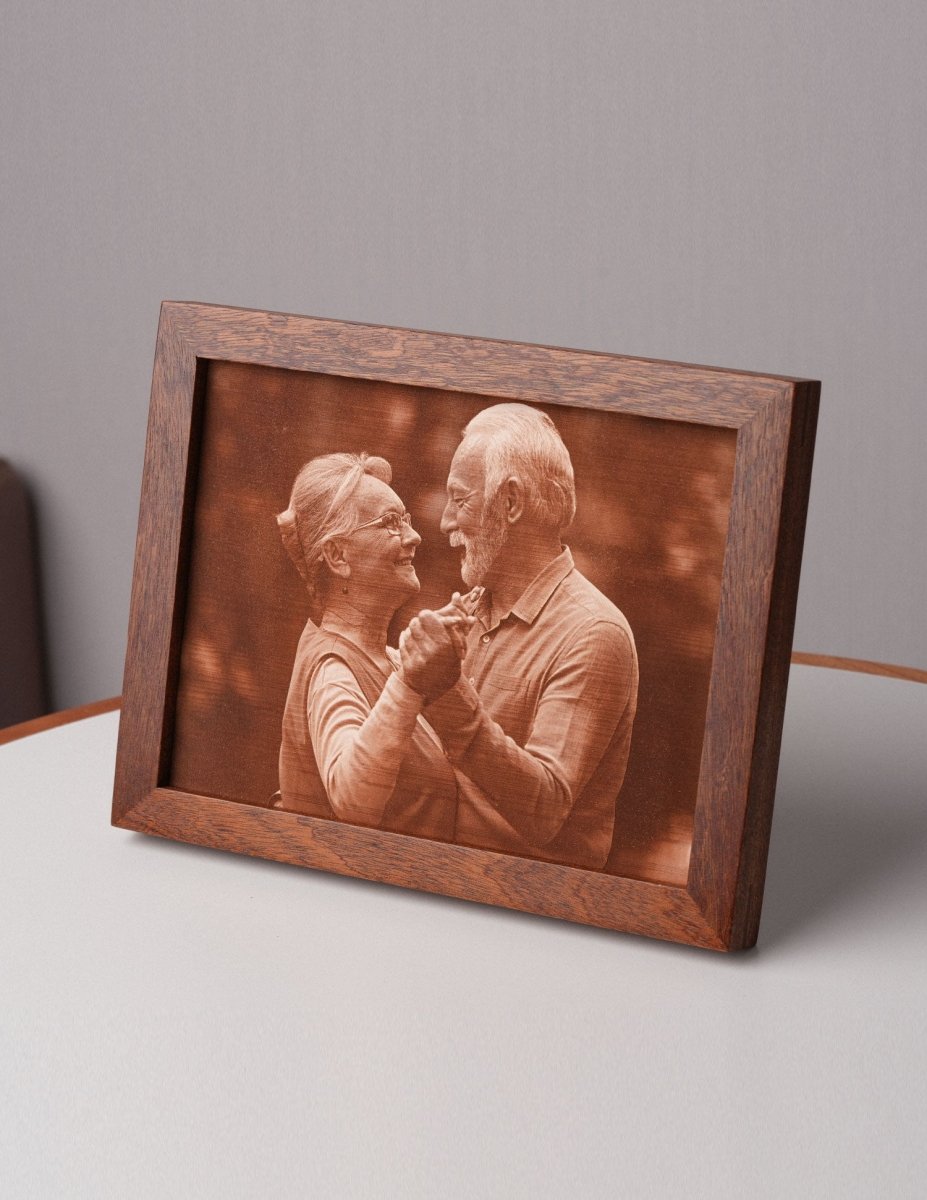 Personalized laser-engraved leather photo of an elderly couple dancing, framed in wood and displayed on a table — a unique and meaningful 3rd wedding anniversary gift