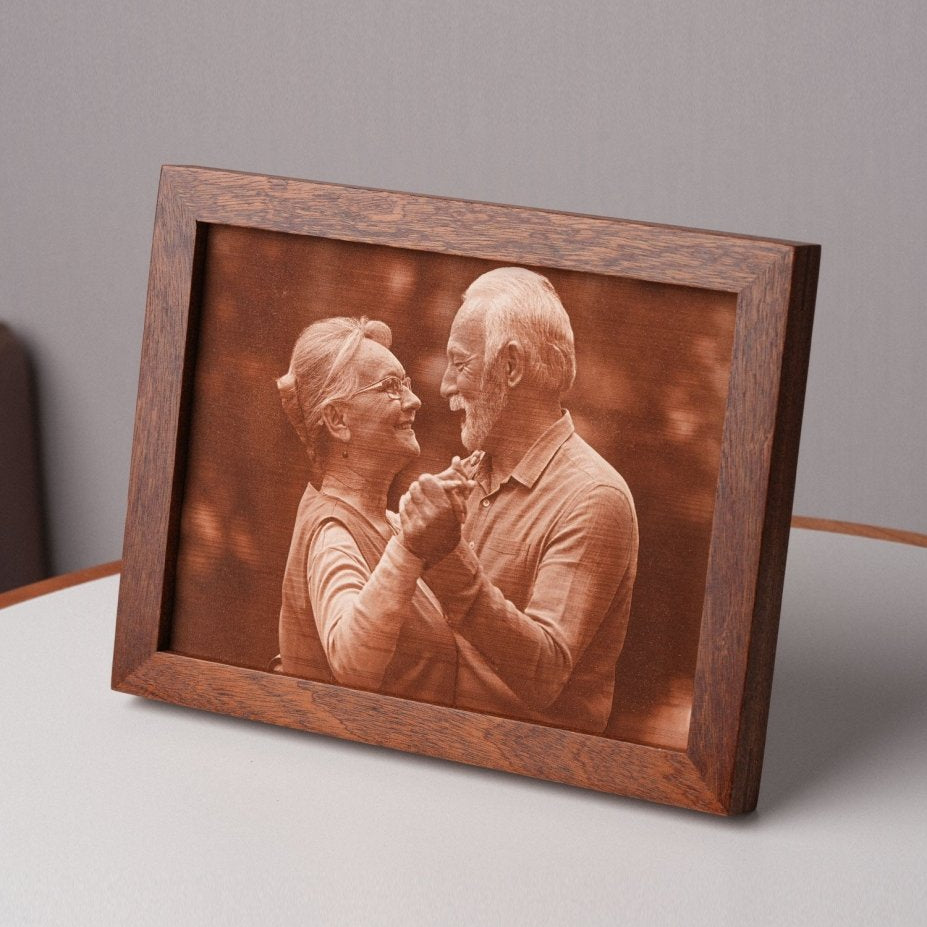 Personalized laser-engraved leather photo of an elderly couple dancing, framed in wood and displayed on a table — a unique and meaningful 3rd wedding anniversary gift