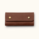 Handcrafted leather SD card holder case with brass snap buttons, perfect for storing memory cards or Nintendo Switch games