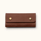 Handcrafted leather SD card holder case with brass snap buttons, perfect for storing memory cards or Nintendo Switch games