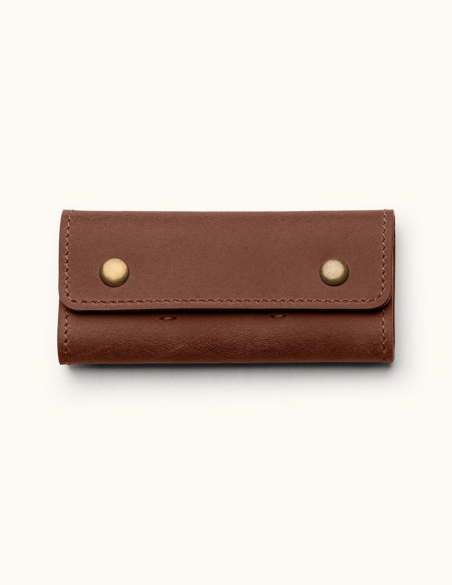 Handcrafted leather SD card holder case with brass snap buttons, perfect for storing memory cards or Nintendo Switch games