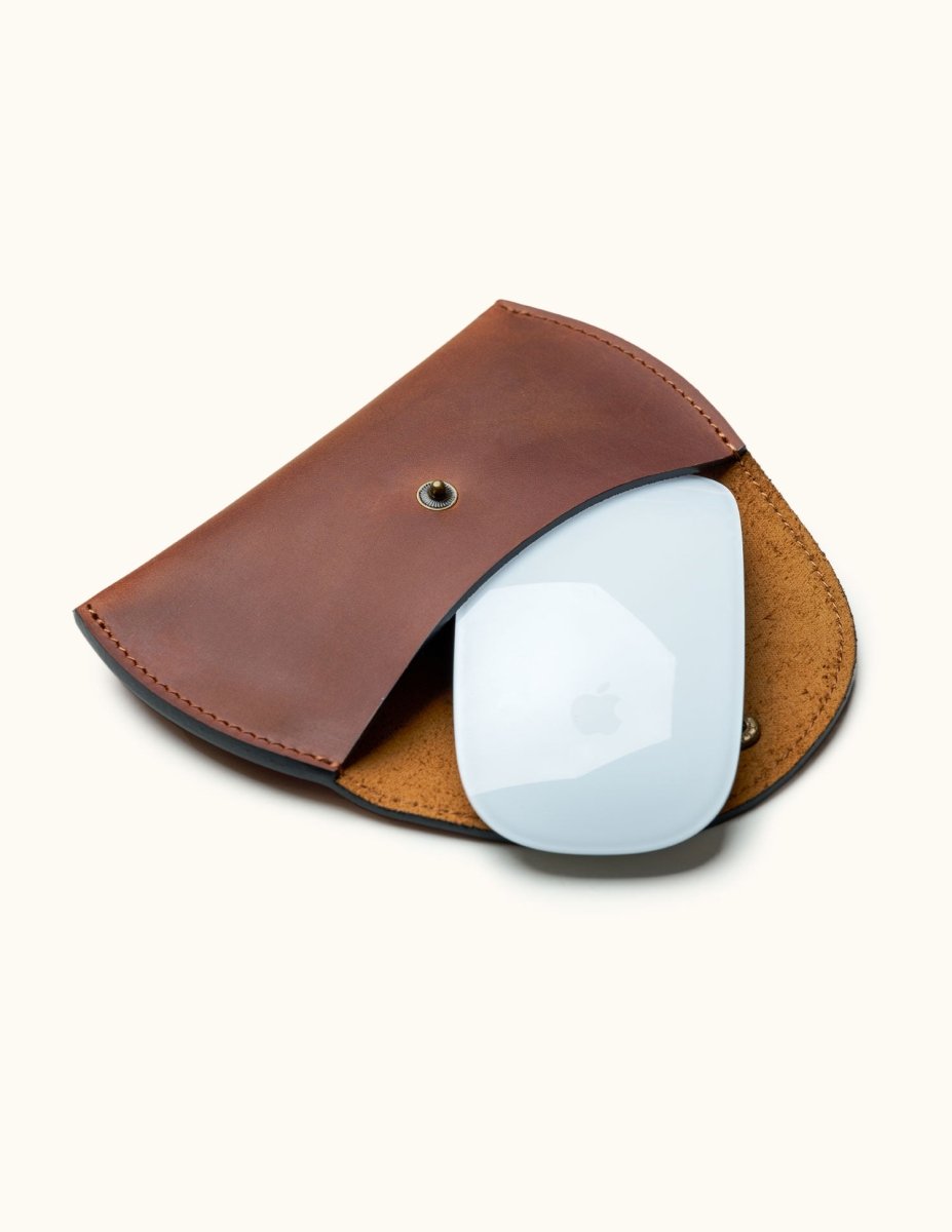 Brown leather case for Apple Magic Mouse, shown open with mouse partially inside