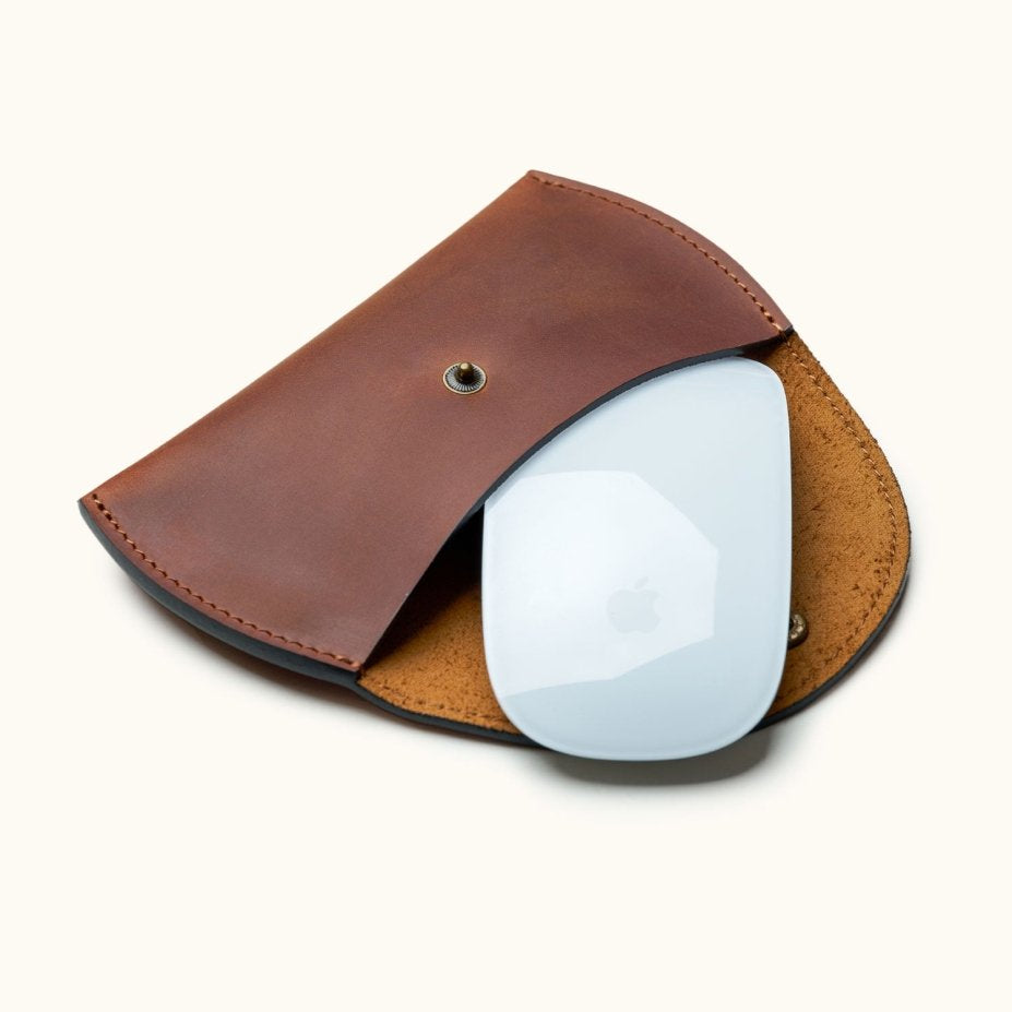 Brown leather case for Apple Magic Mouse, shown open with mouse partially inside