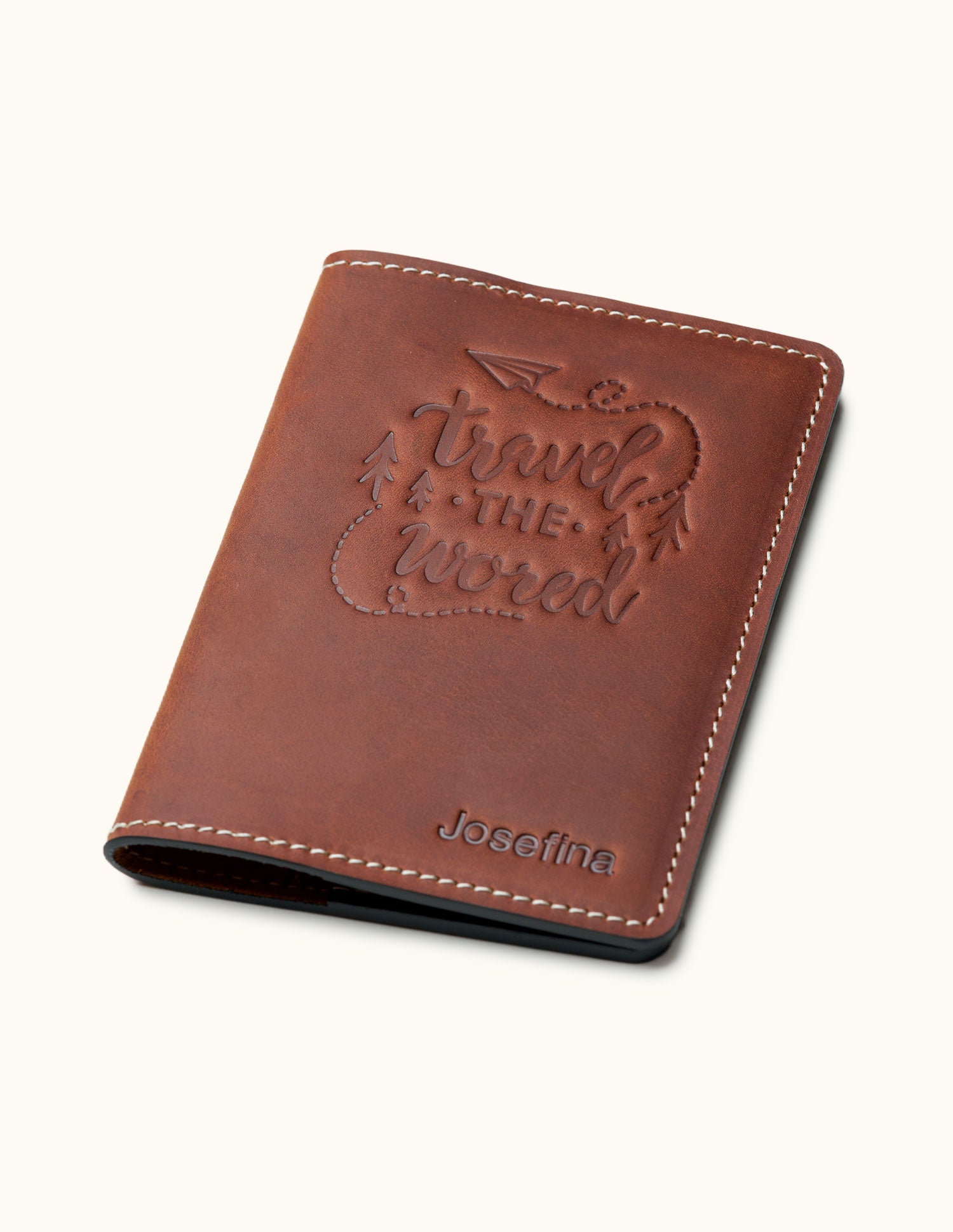 Vintage brown leather passport cover with 'Travel the World' embossed design and personalized name Josefina