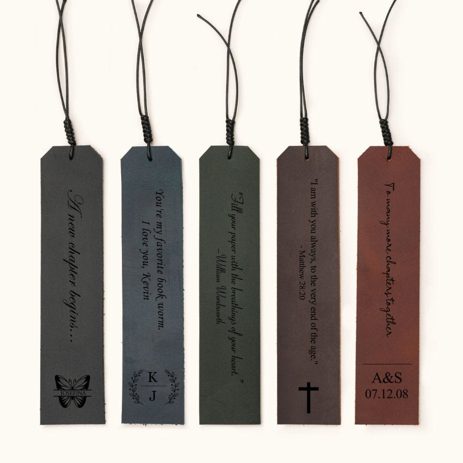 Five personalized leather bookmarks in different colors, each engraved with custom quotes, initials, or dates, with decorative tassel cords on top