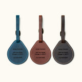 Custom engraved leather luggage tags in blue, brown, and black with name, address, and phone number